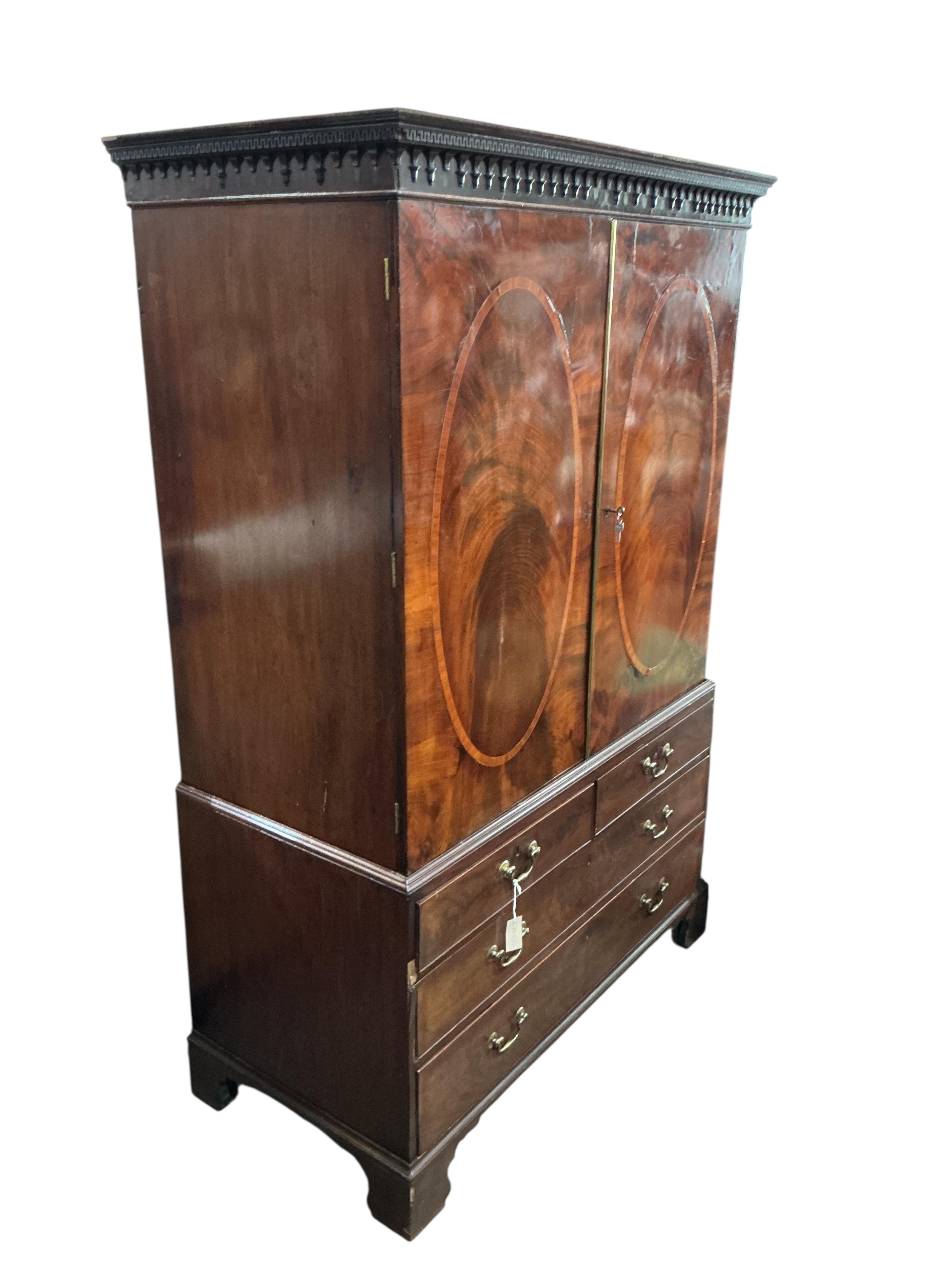 A George III banded mahogany linen press, width 128cm, depth 65cm, height 196cm